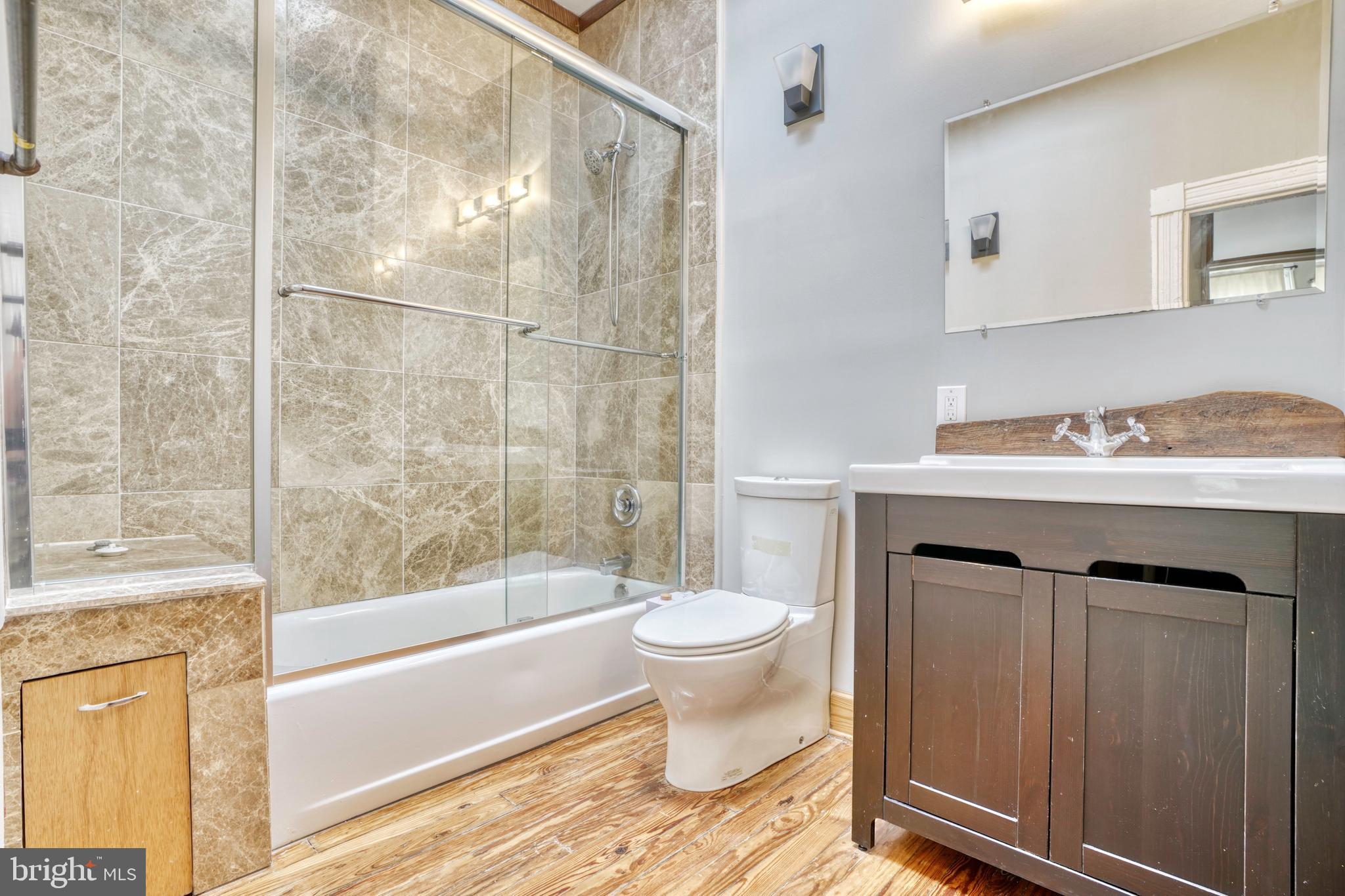 343 East 21st Street Baltimore, MD 21218 - Photo 14 of 22 a bathroom with a sink toilet vanity and shower