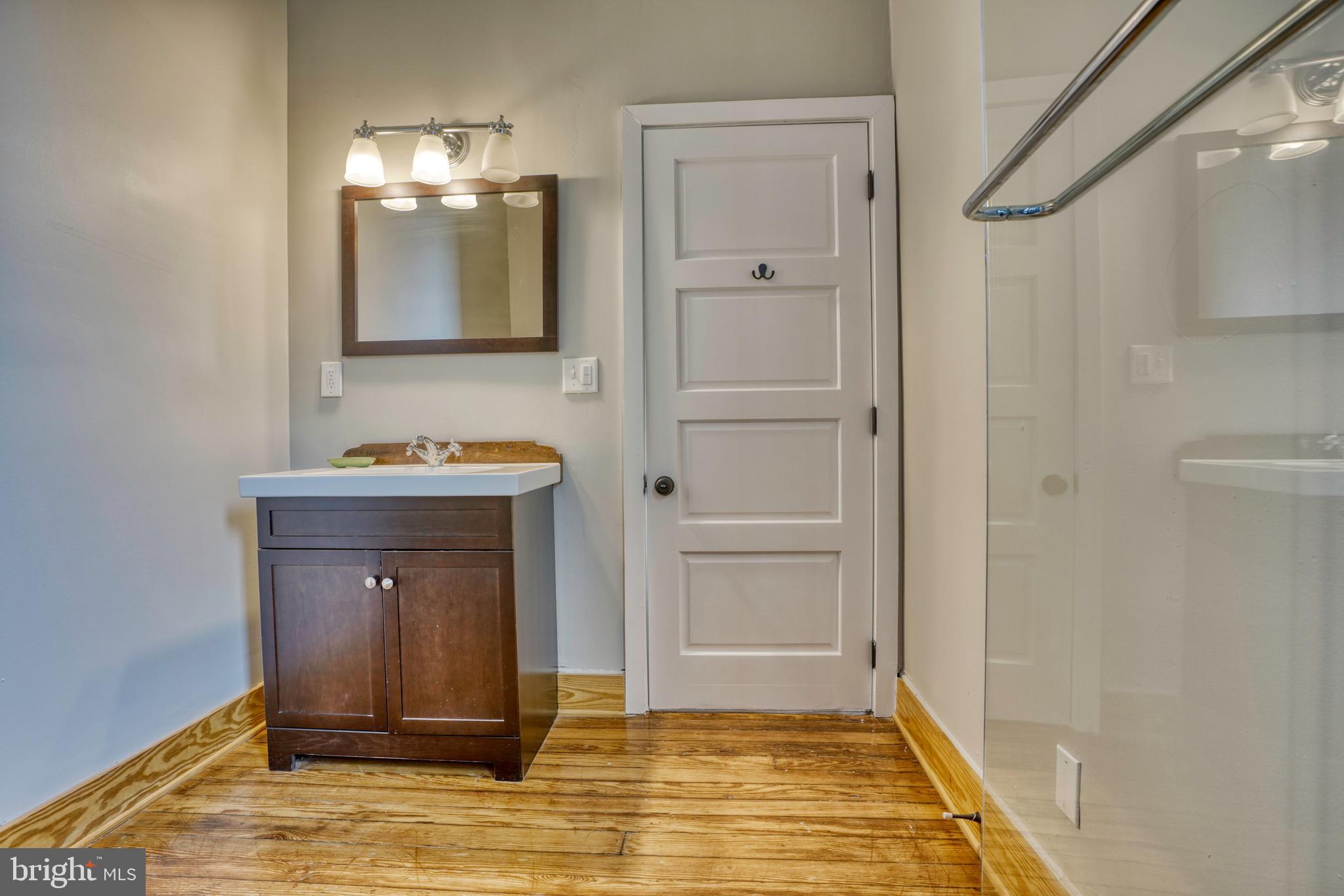 343 East 21st Street Baltimore, MD 21218 - Photo 20 of 22 a bathroom with a sink and a mirror