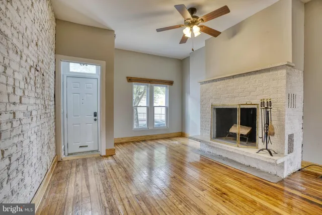 a view of a livingroom with a fireplace and wooden floor