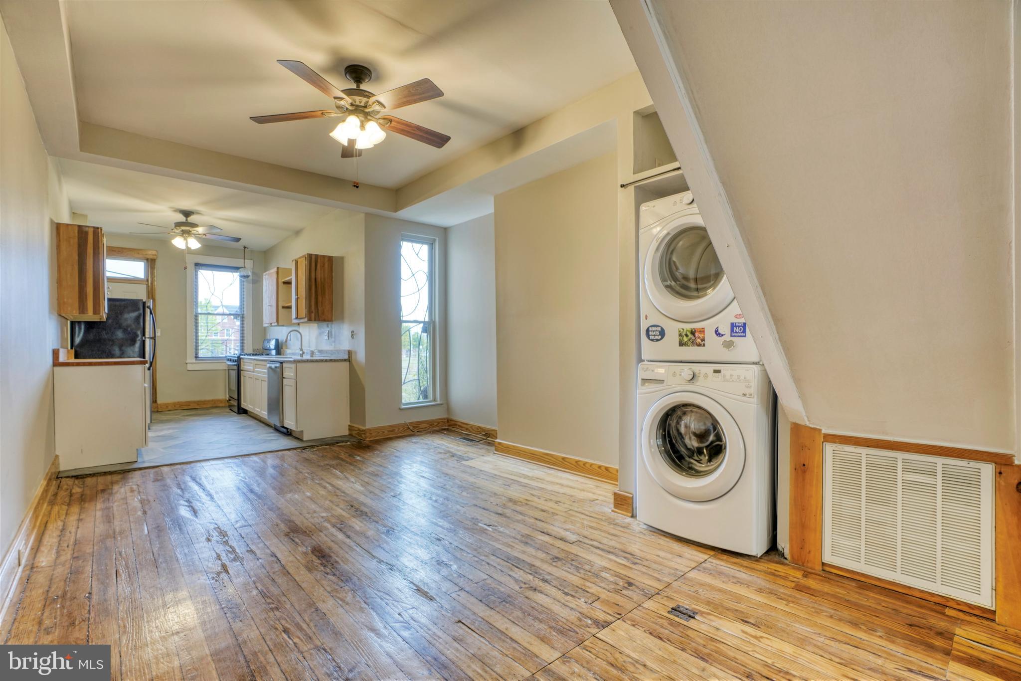 343 East 21st Street Baltimore, MD 21218 - Photo 5 of 22 a view of a hallway with wooden floor and a kitchen