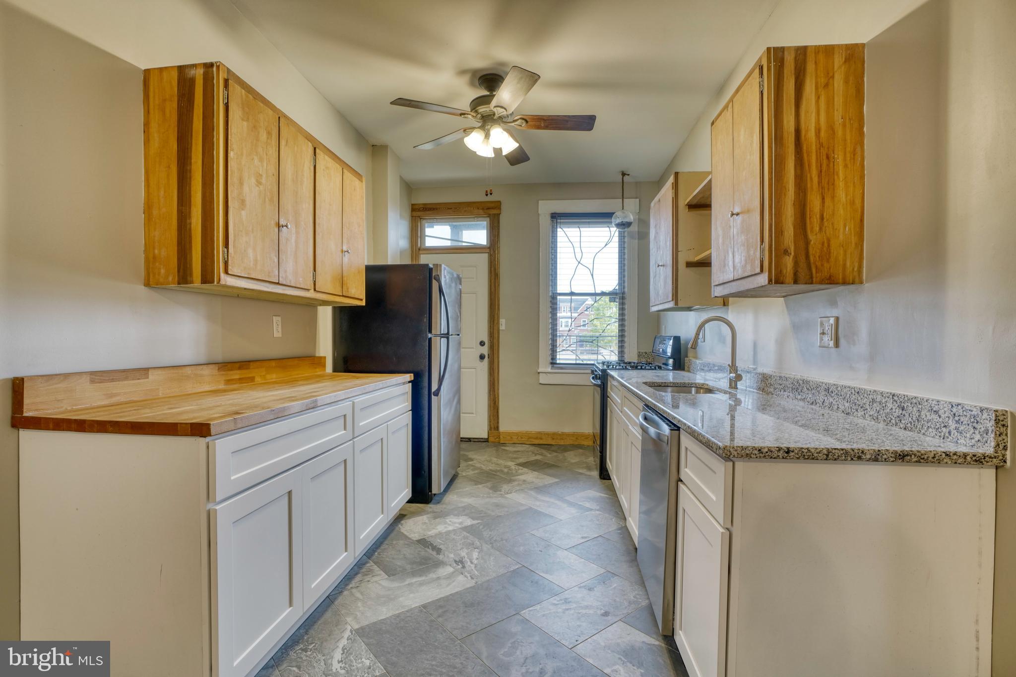 343 East 21st Street Baltimore, MD 21218 - Photo 7 of 22 a kitchen with a sink stove and cabinets