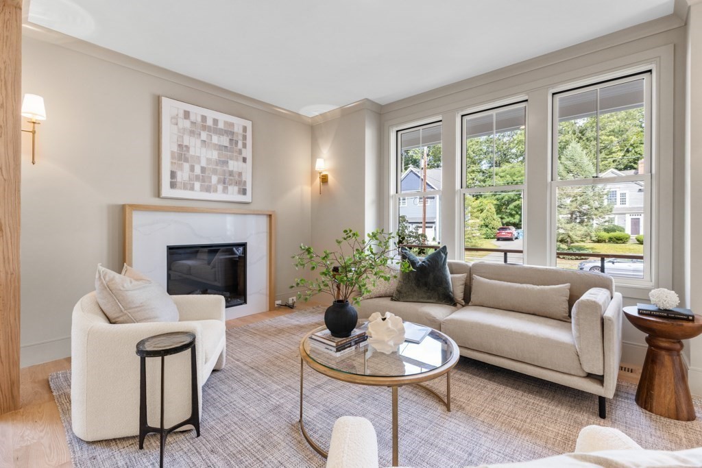 107 Valley Road Needham, MA 02492 - Photo 11 of 36 a living room with furniture potted plant and a fireplace