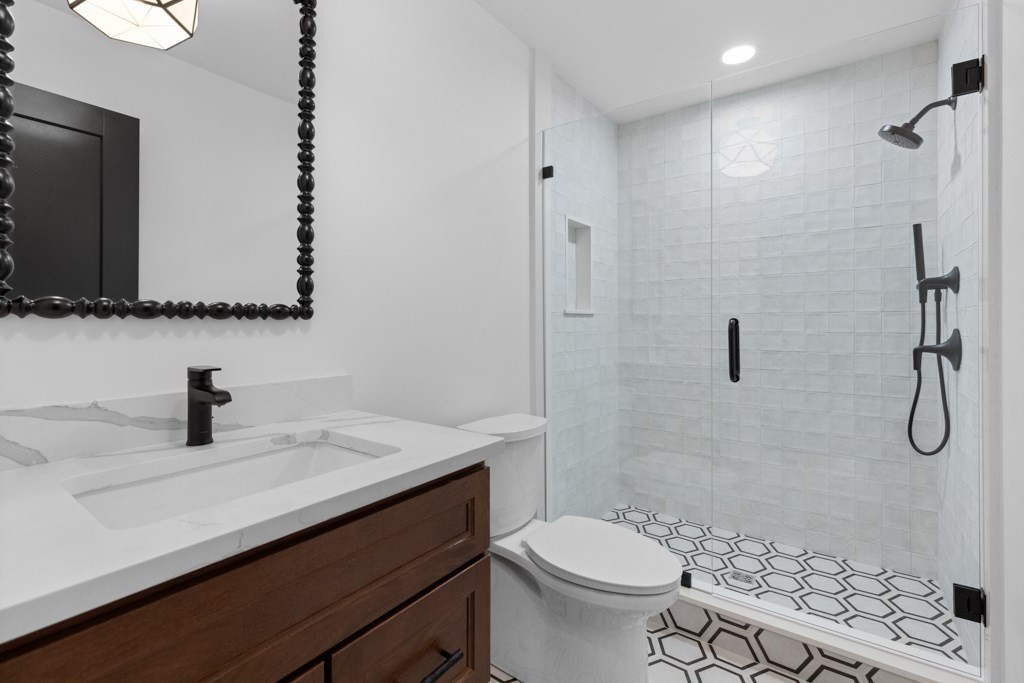 107 Valley Road Needham, MA 02492 - Photo 17 of 36 a bathroom with a sink a toilet and shower