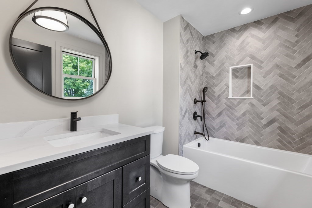 107 Valley Road Needham, MA 02492 - Photo 19 of 36 a bathroom with a sink a toilet and a mirror