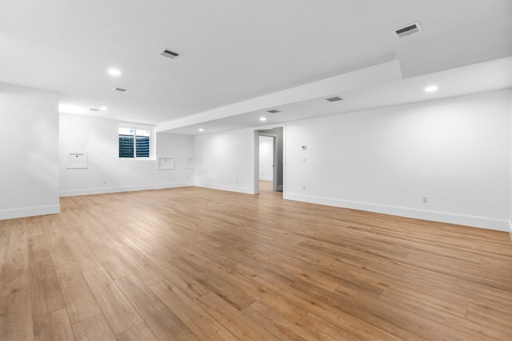 107 Valley Road Needham, MA 02492 - Photo 28 of 36 a view of an empty room with wooden floor and a window