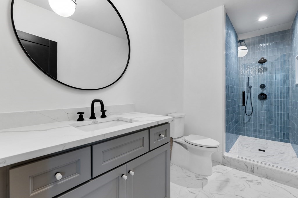 107 Valley Road Needham, MA 02492 - Photo 30 of 36 a bathroom with a sink a toilet and shower