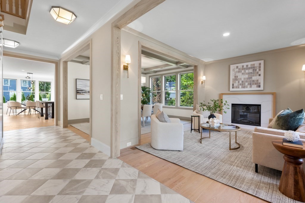 107 Valley Road Needham, MA 02492 - Photo 3 of 36 a living room with furniture a dining table and a fireplace