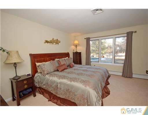 196 Friendship Road Cranbury, NJ 08512 - Photo 11 of 25 a bedroom with a bed and a night stand