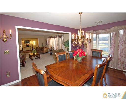 196 Friendship Road Cranbury, NJ 08512 - Photo 17 of 25 a living room with furniture dining table and a chandelier