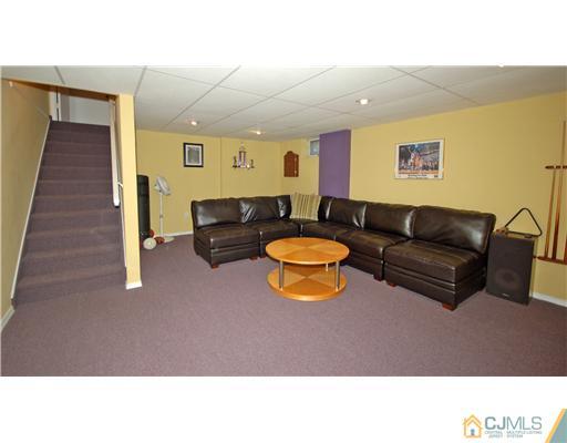 196 Friendship Road Cranbury, NJ 08512 - Photo 19 of 25 a living room with furniture and a rug