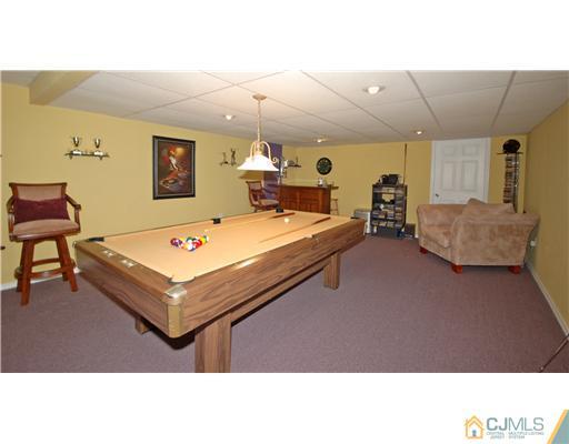 196 Friendship Road Cranbury, NJ 08512 - Photo 20 of 25 a living room with furniture pool table and wall paintings
