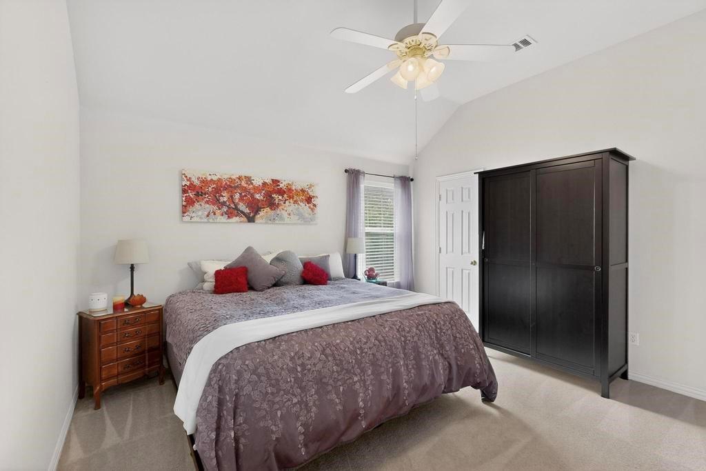 236 Hope Circle Murphy, TX 75094 - Photo 23 of 37 Bedroom with a walk in closet, vaulted ceiling, and ceiling fan