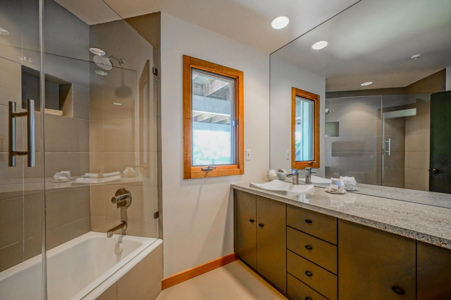 211 Crest Road Carmel, CA 93923 - Photo 14 of 21 a bathroom with a double vanity sink tub and mirror