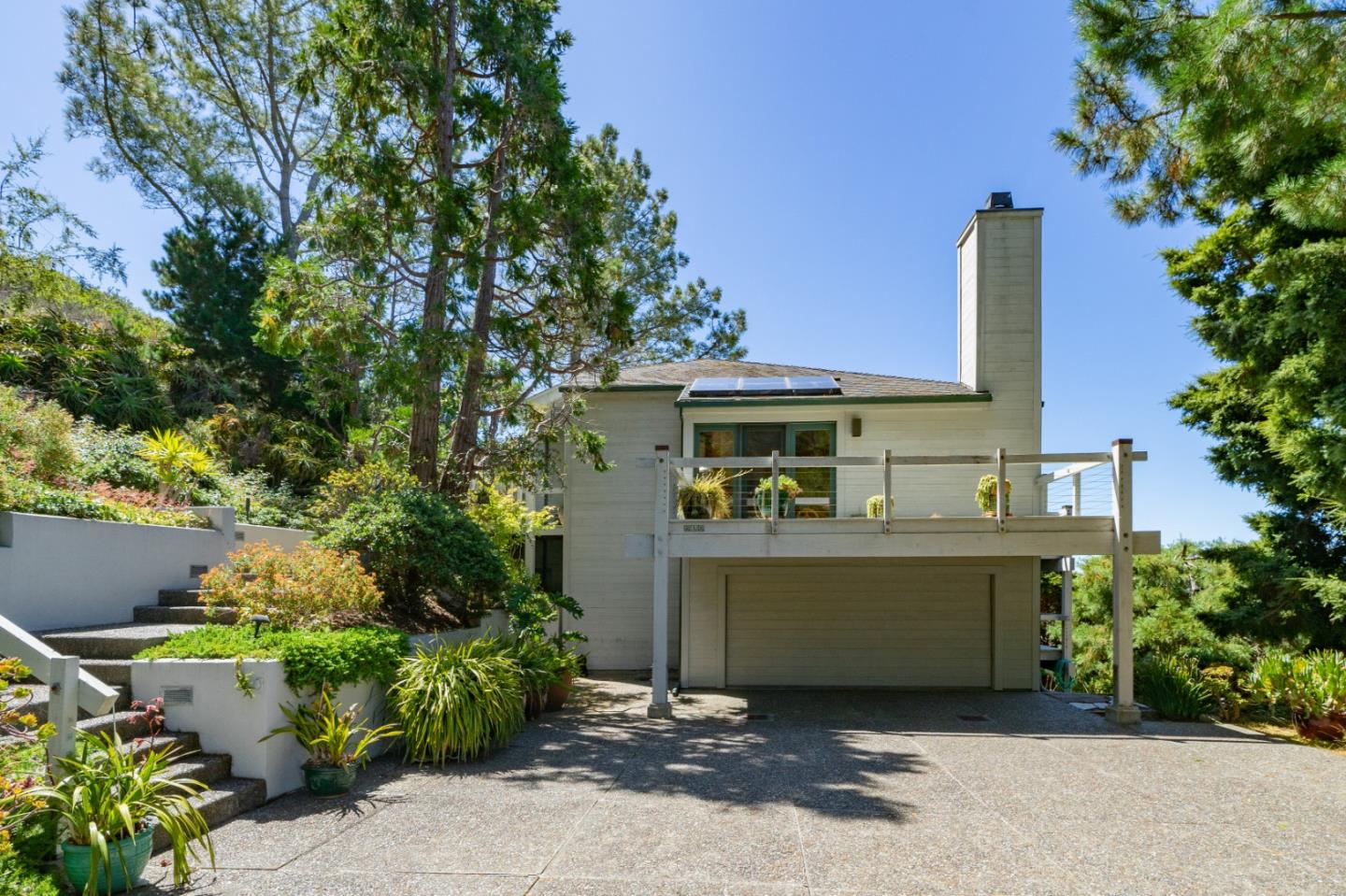 211 Crest Road Carmel, CA 93923 - Photo 3 of 21 a view of a house with a fountain plants and a patio
