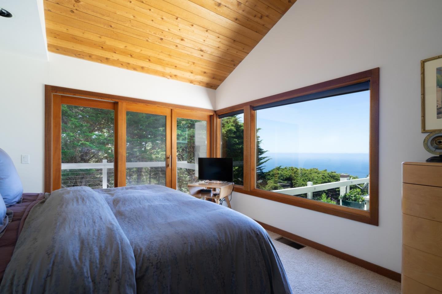 211 Crest Road Carmel, CA 93923 - Photo 5 of 21 a bed sitting in a bedroom next to a large window