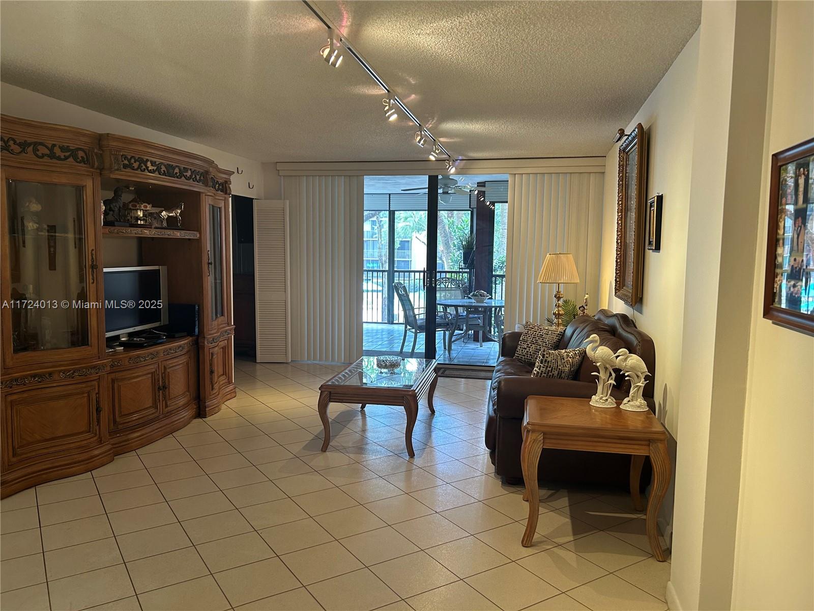 2802 North 46th Avenue, Unit B319 Hollywood, FL 33021 - Photo 16 of 40 a living room with furniture and a flat screen tv