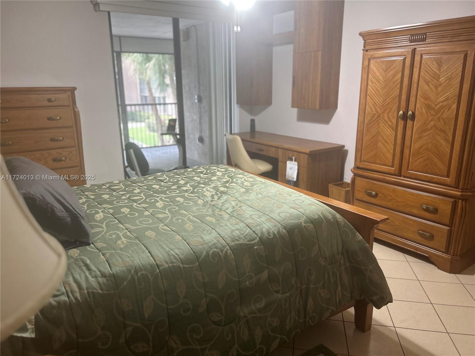 2802 North 46th Avenue, Unit B319 Hollywood, FL 33021 - Photo 19 of 40 a bedroom with a bed and a window