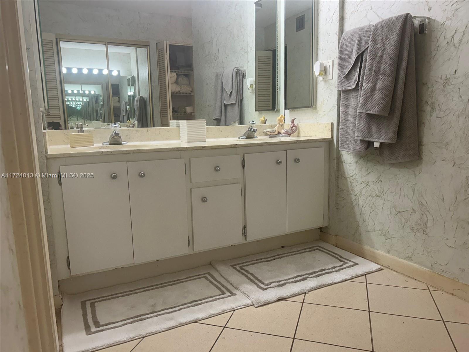 2802 North 46th Avenue, Unit B319 Hollywood, FL 33021 - Photo 20 of 40 a bathroom with a sink and a mirror