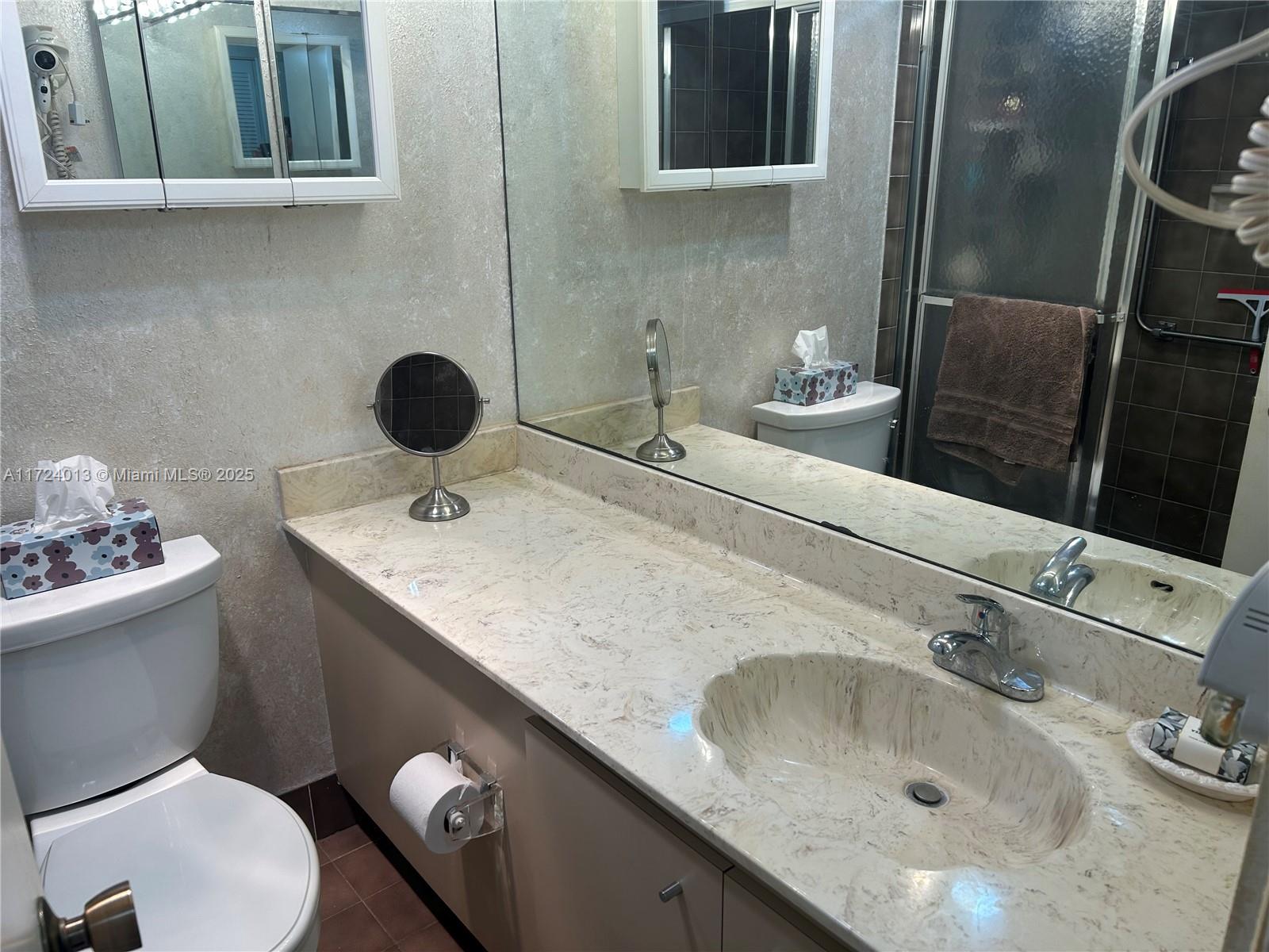 2802 North 46th Avenue, Unit B319 Hollywood, FL 33021 - Photo 24 of 40 a bathroom with a sink and a toilet