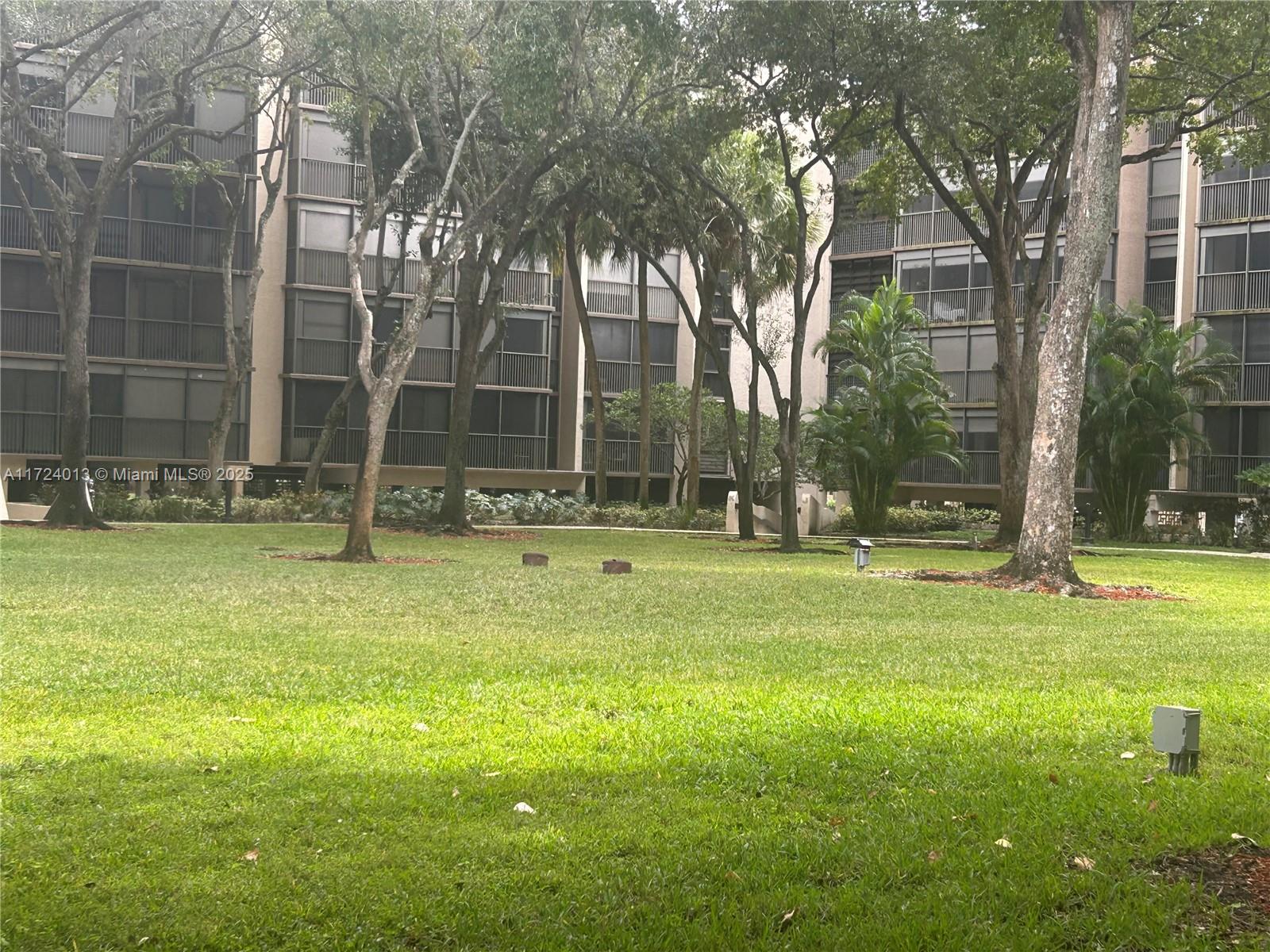2802 North 46th Avenue, Unit B319 Hollywood, FL 33021 - Photo 26 of 40 a backyard of a house with lots of green space and fountain
