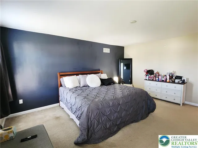 a bedroom with a bed and a book shelf