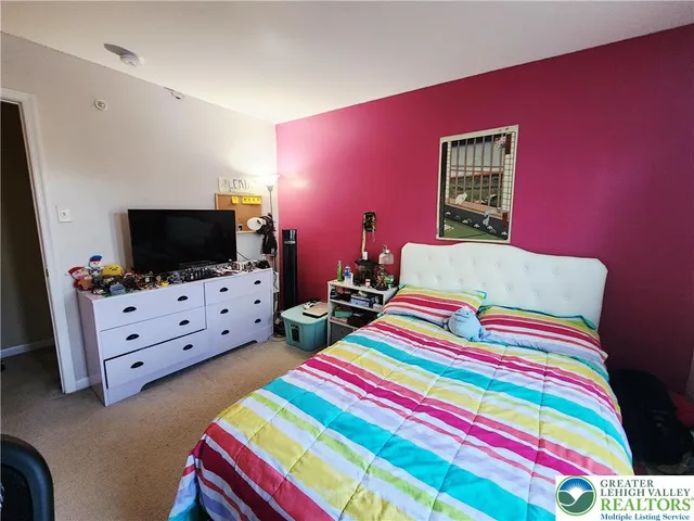 a room that has a bed and a flat screen tv