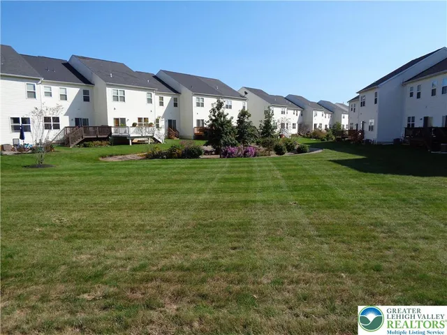 a city view with tall buildings and a yard