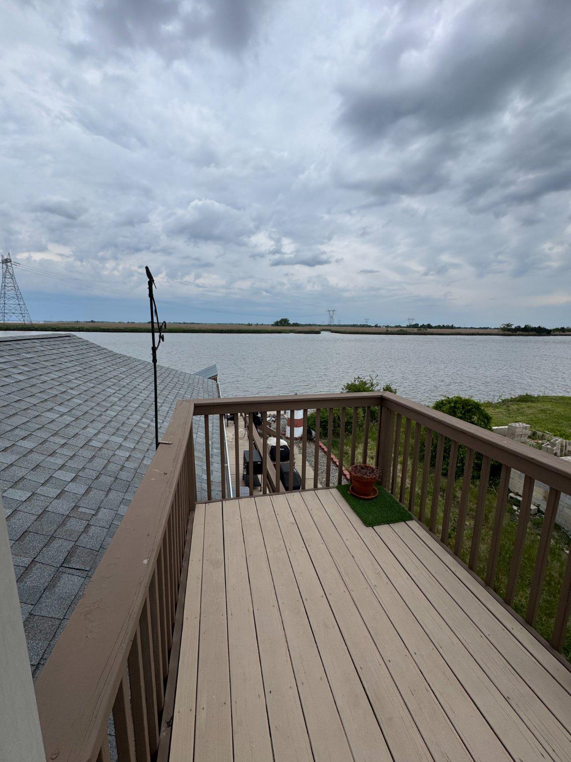 74 Sinnickson Landing Road Salem, NJ 08079 - Photo 28 of 51 a view of deck with two chairs next to an ocean