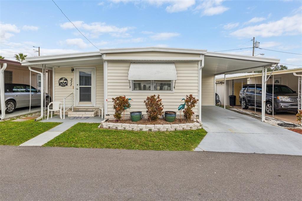 a view of a house with sitting area and garden
