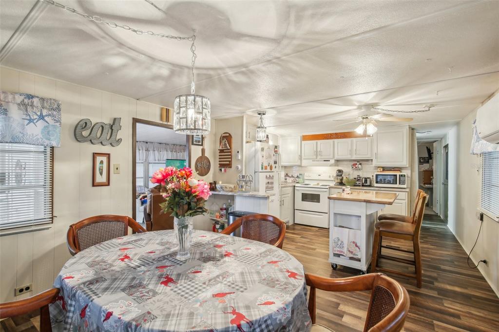1600 Old Coachman Rd., Unit 311 Clearwater, FL 33765 - Photo 12 of 27 a very nice looking dining room with kitchen island granite countertop furniture and a dining table