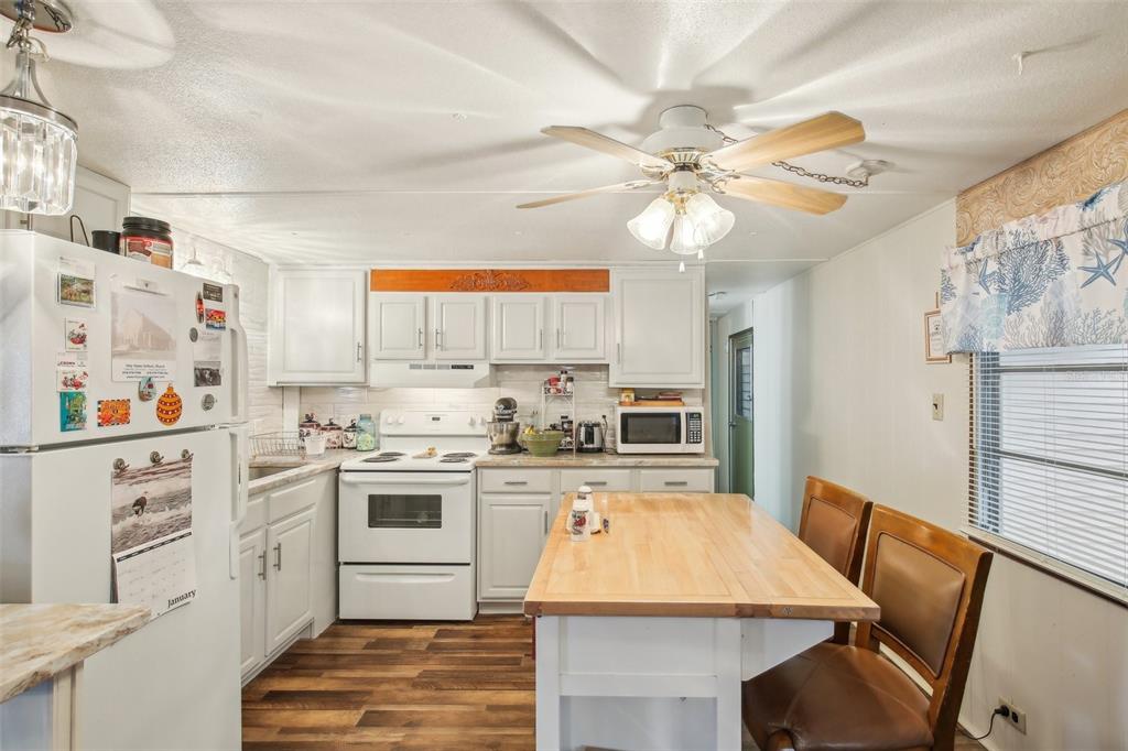 1600 Old Coachman Rd., Unit 311 Clearwater, FL 33765 - Photo 15 of 27 a kitchen with cabinets a island and appliances