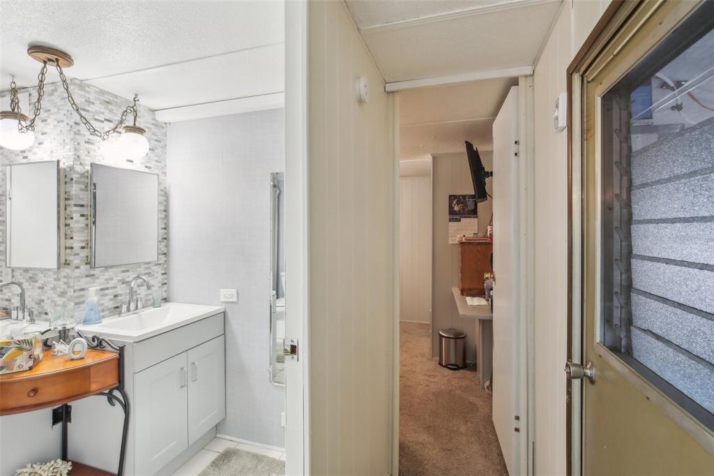 1600 Old Coachman Rd., Unit 311 Clearwater, FL 33765 - Photo 20 of 27 a bathroom with a sink vanity and a mirror