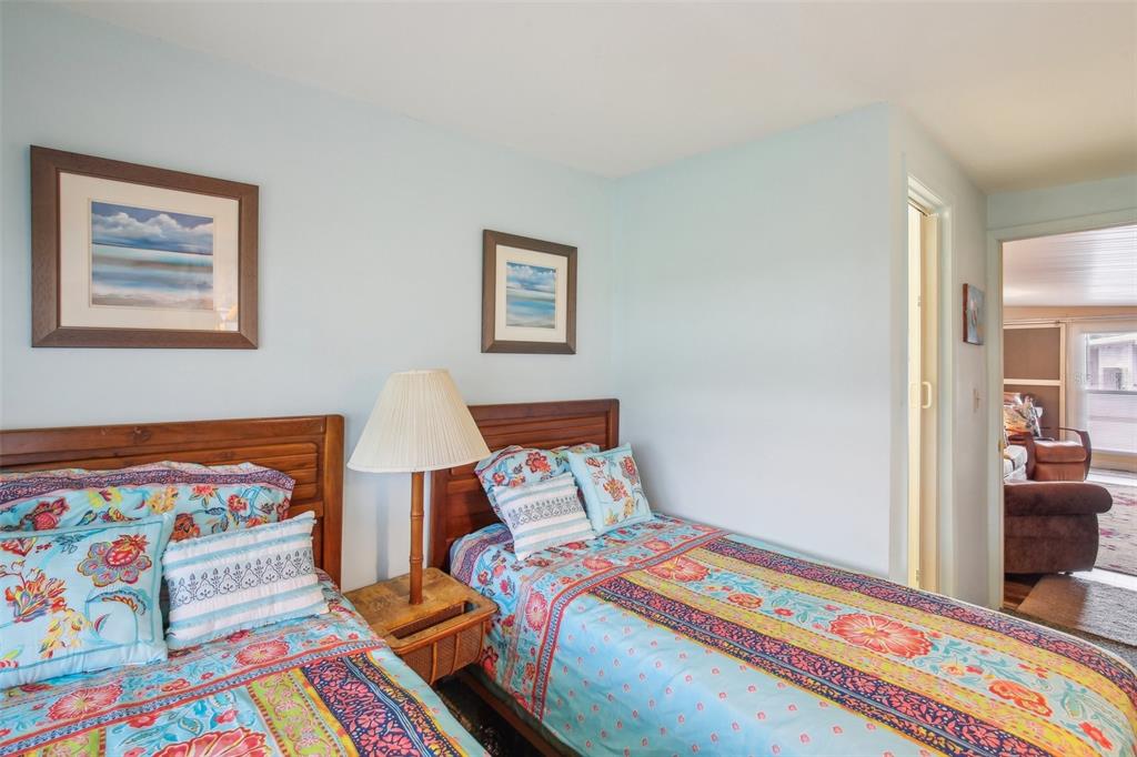 1600 Old Coachman Rd., Unit 311 Clearwater, FL 33765 - Photo 24 of 27 a bedroom with a bed and a painting on the wall