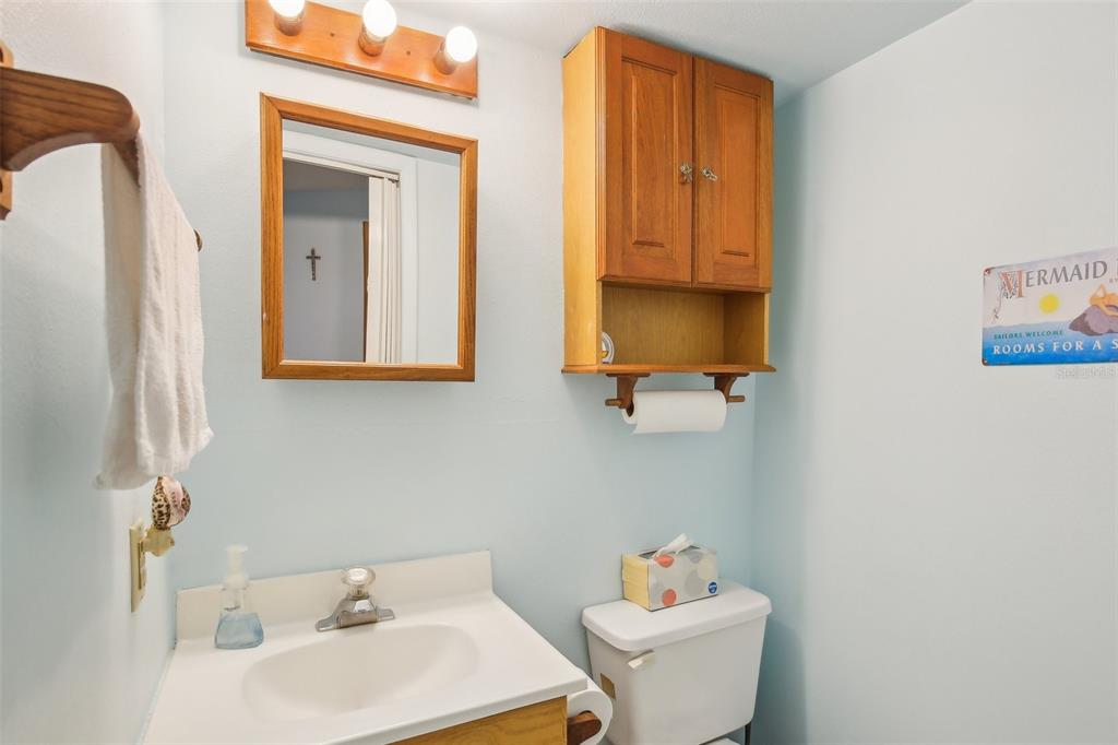 1600 Old Coachman Rd., Unit 311 Clearwater, FL 33765 - Photo 25 of 27 a bathroom with a sink toilet and mirror
