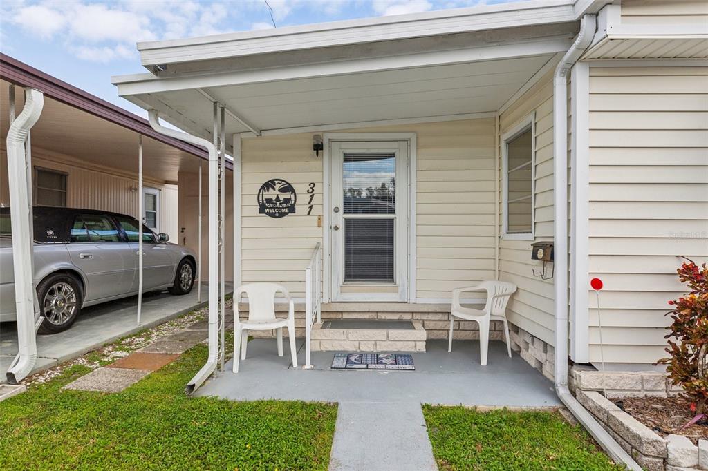 1600 Old Coachman Rd., Unit 311 Clearwater, FL 33765 - Photo 4 of 27 a view of a two chairs in the patio