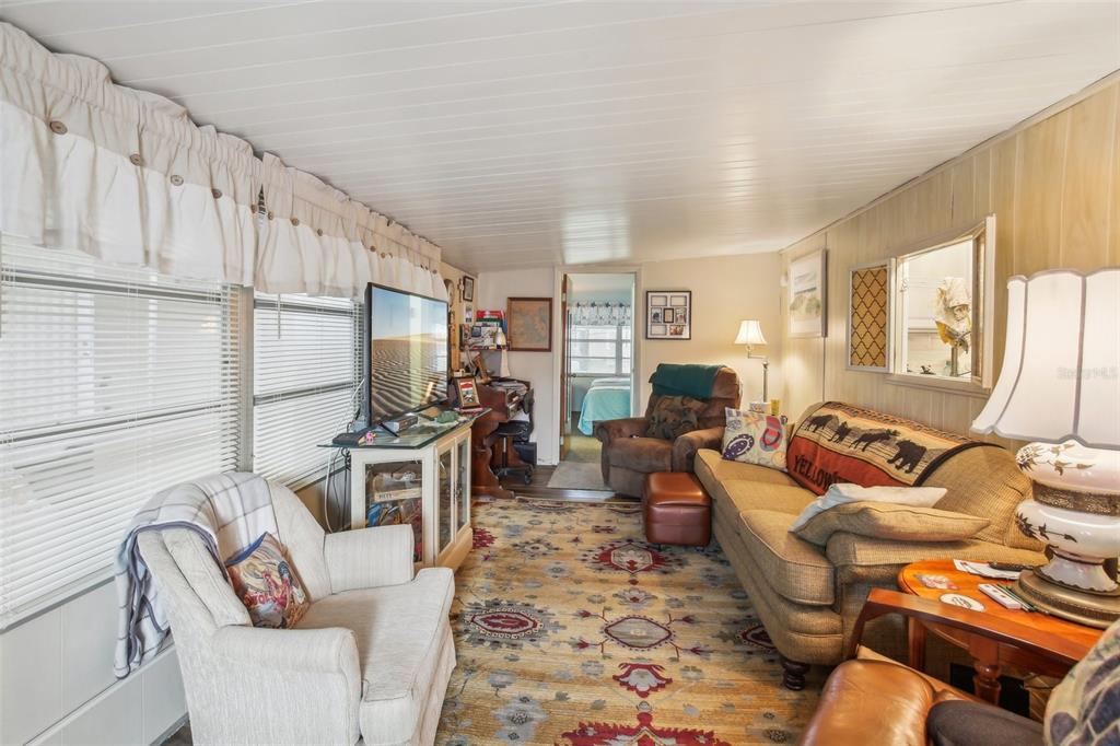 1600 Old Coachman Rd., Unit 311 Clearwater, FL 33765 - Photo 7 of 27 a living room with furniture fireplace and a flat screen tv