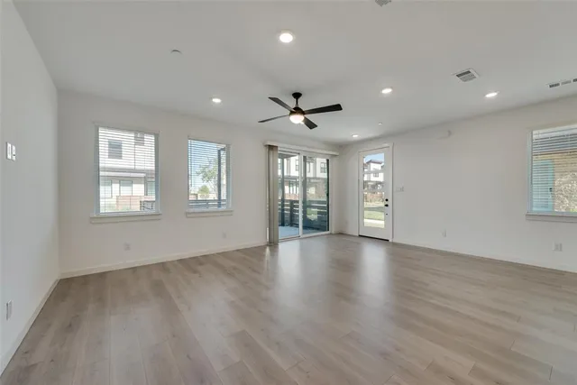 a view of a hallway with stairs and a window