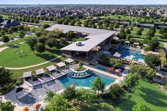 an aerial view of a residential houses with outdoor space and street view