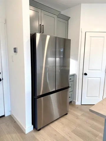 a kitchen with stainless steel appliances a sink and a refrigerator