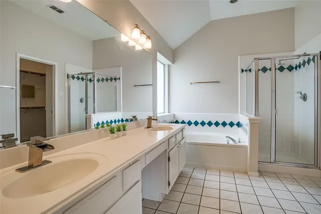 a bathroom with a sink double vanity and a shower