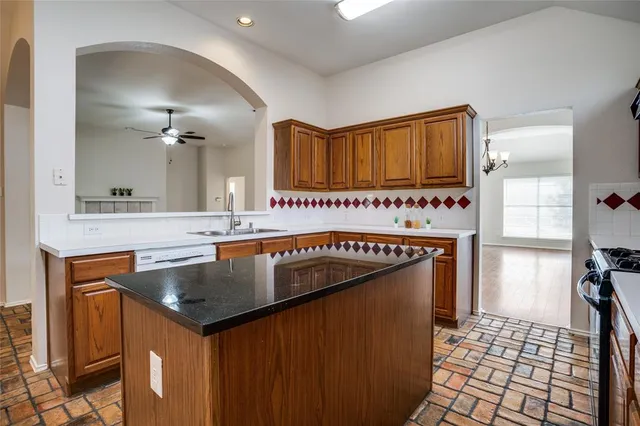 a kitchen with a sink a stove and cabinets