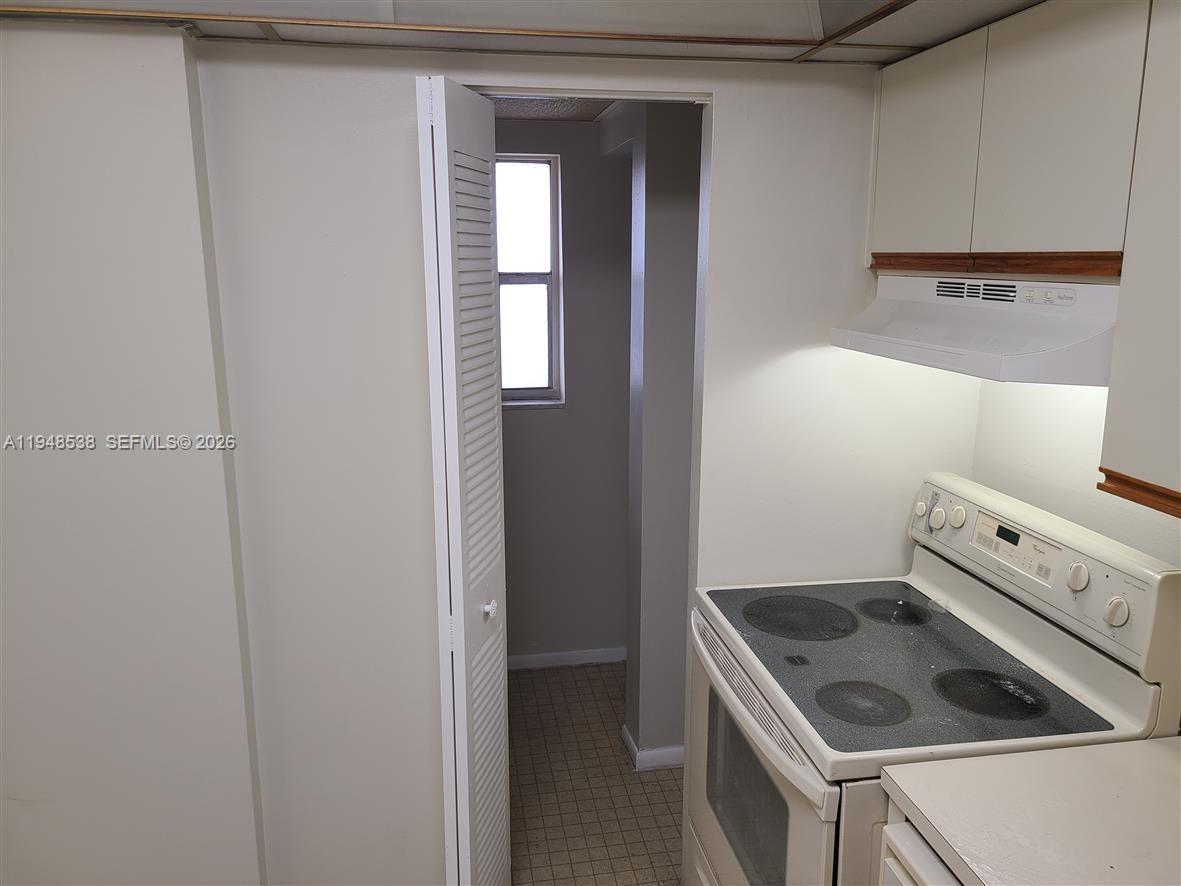 7925 South Colony Circle, Unit 207 Tamarac, FL 33321 - Photo 5 of 10 a kitchen with a stove and a sink