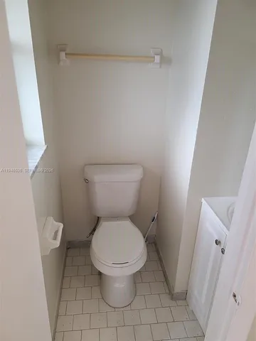 a white toilet sitting next to a bathroom sink