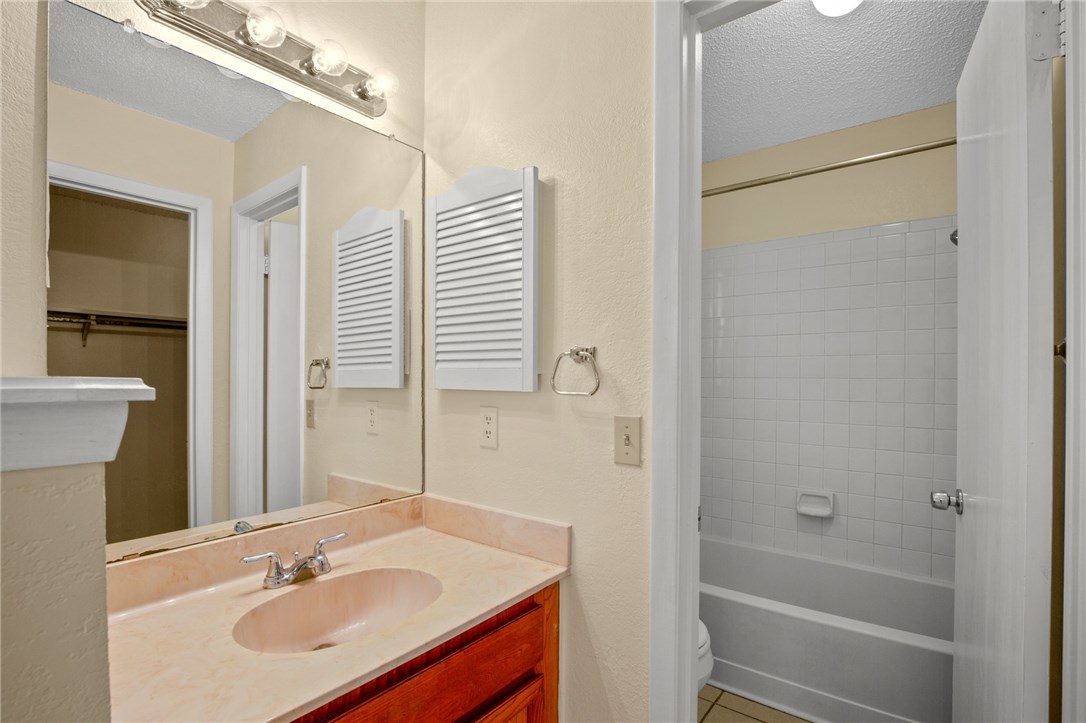 12213 Tyson Cove, Unit B Austin, TX 78758 - Photo 11 of 15 a bathroom with a sink toilet and shower