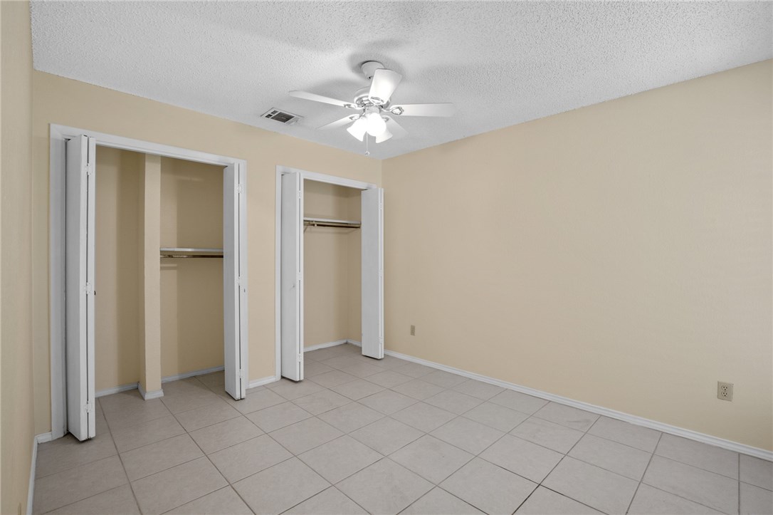 12213 Tyson Cove, Unit B Austin, TX 78758 - Photo 12 of 15 an empty room with closet and a chandelier fan