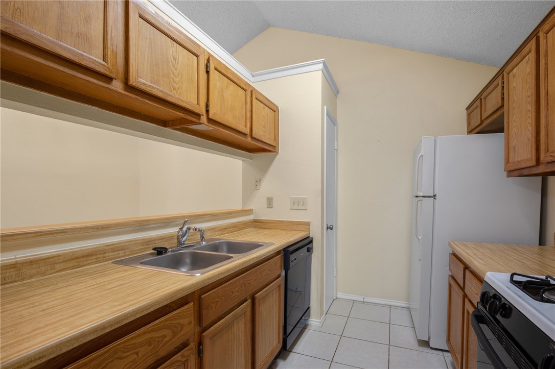 12213 Tyson Cove, Unit B Austin, TX 78758 - Photo 8 of 15 a utility room with cabinets