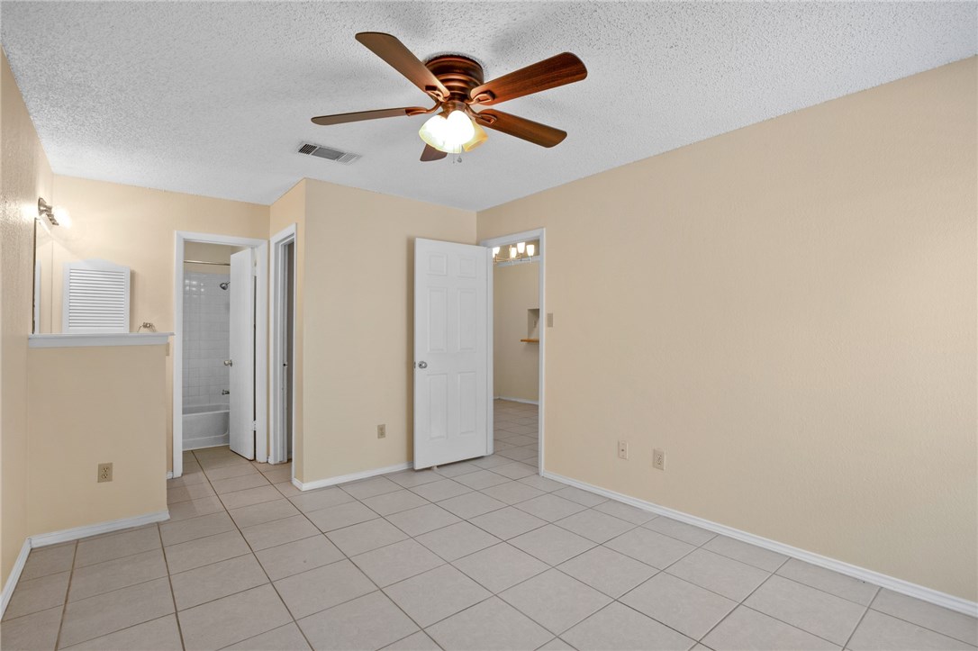 12213 Tyson Cove, Unit B Austin, TX 78758 - Photo 10 of 15 an empty room with closet and ceiling fan