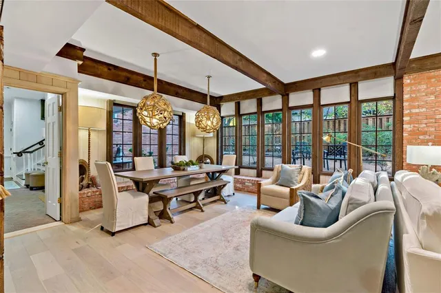 a living room with furniture a large window and a rug
