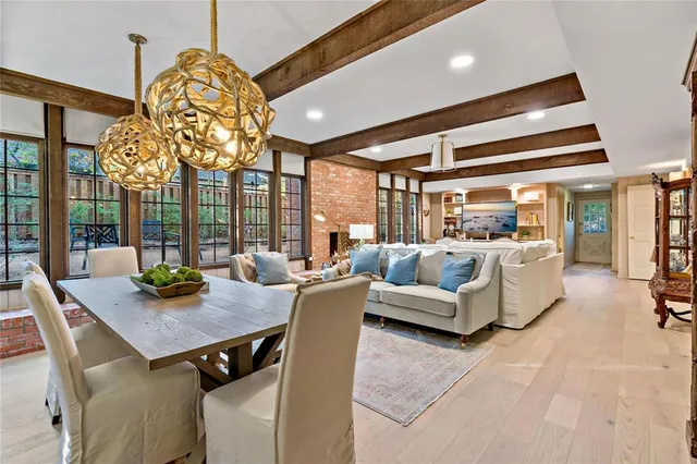 a view of a dining room with furniture wooden floor and chandelier