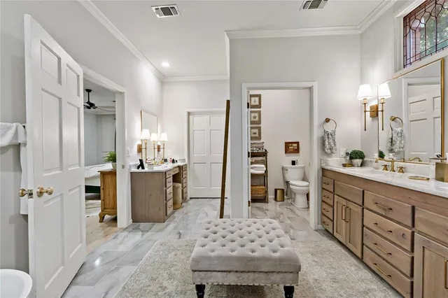 a spacious bathroom with a double vanity sink a mirror a bathtub and shower